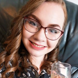 Jess Ballard with a glass of champagne celebrating her Instagram wins